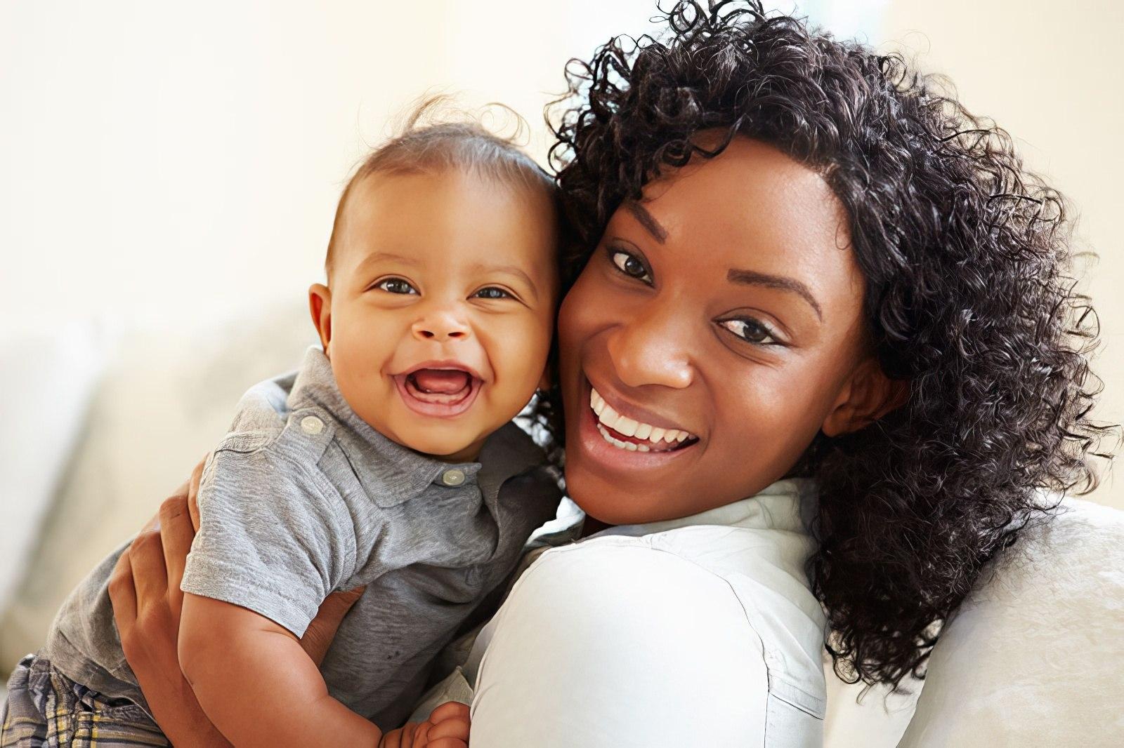 Mom holding her baby and smiling