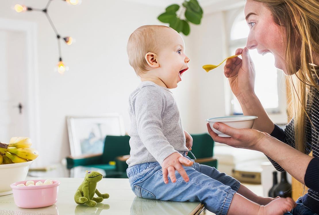 Mom feeding son on the counter